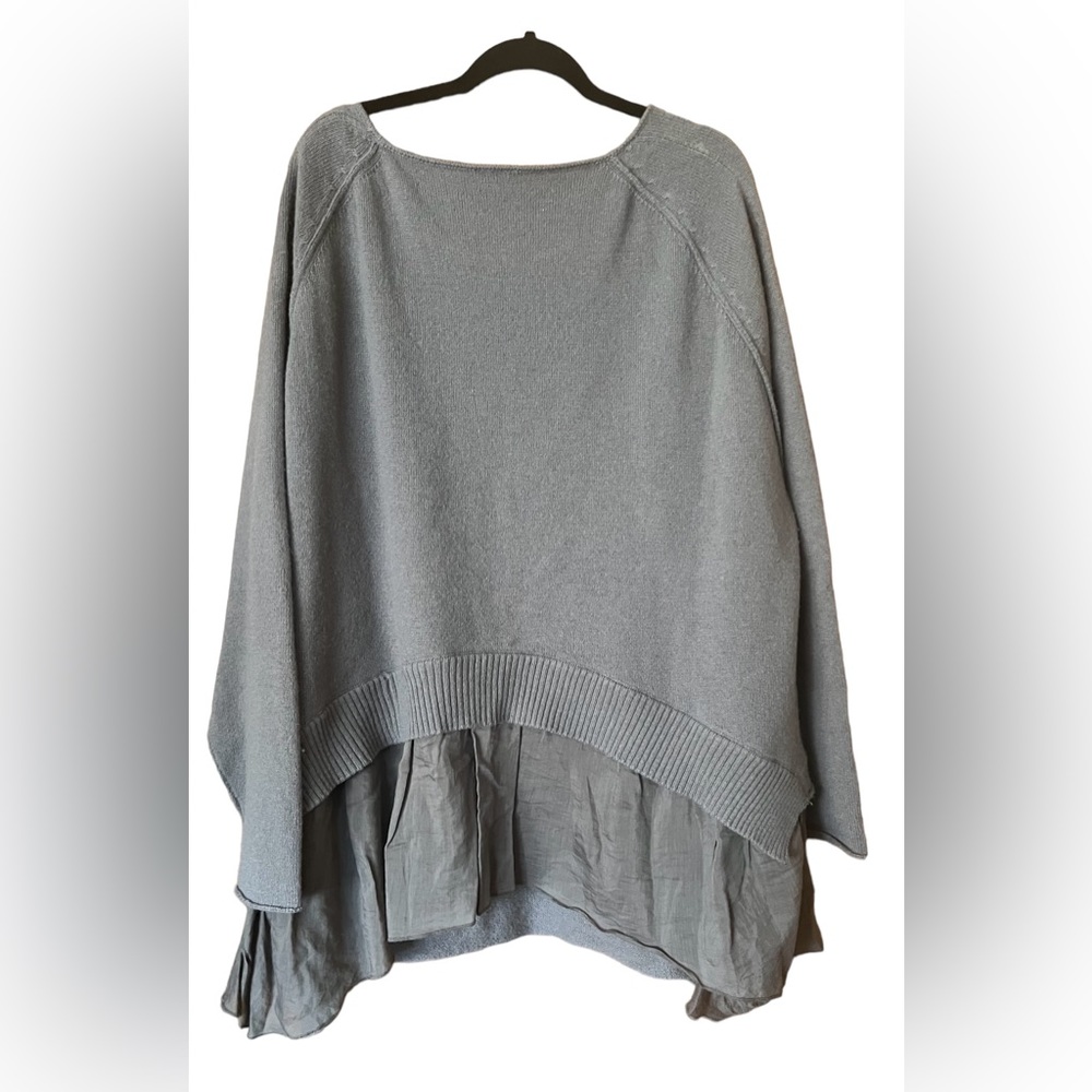 Women’s over sized sweater with ruffle bottom.